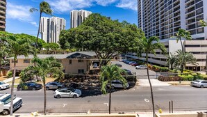 A multi-story parking garage with cars parked on multiple levels. - Waikiki Beach Airbnb | Pool, Parking,Walk to Beach (Honolulu)