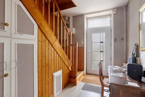 A wooden staircase leading to a room with a door, a desk with papers, and a chair. - Le paradis - Guest Room P (Chaillé-les-Marais)