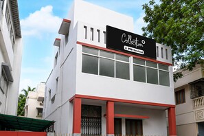 A modern building with a sign indicating it is serviced by OYO. - Deluxe The Royal Orbit (Barasat)