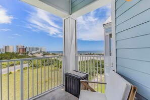 A balcony with a view of the beach and cityscape. - 🏖️ Grand Caribbean 423 | 2BR Orange Beach | Steps to Beach + Pool + Fitness (Orange Beach)