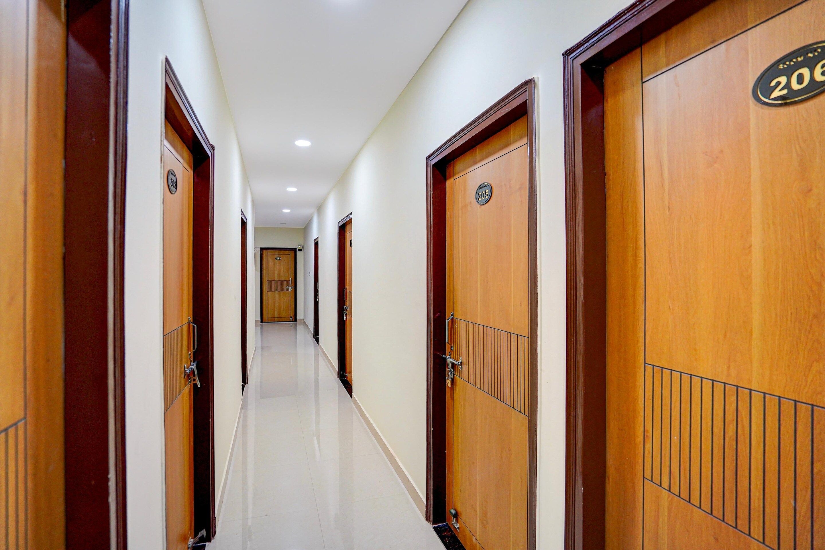 A corridor with wooden doors, each marked with a number.