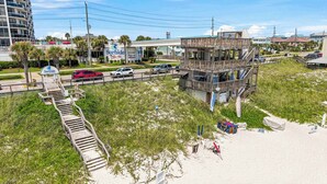 A beachside resort with a lifeguard tower, a boardwalk leading to the beach, and a Surfside sign. - Beach View Studio with Private Balcony, Pool, Hot Tub & Resort Access (Miramar Beach)