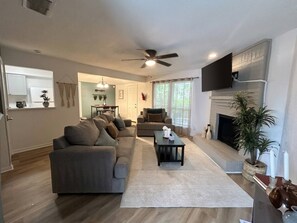 A modern living room with a sofa, a coffee table, and a fireplace. - Welcoming 2-bedroom house with AC in Arlington, near AT&T Stadium &Six Flags (Arlington)