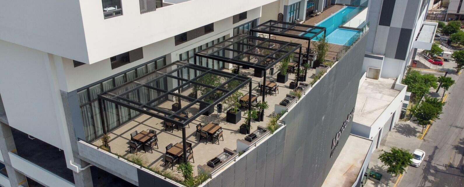 A rooftop terrace with outdoor seating and a swimming pool.