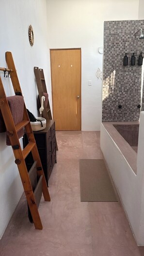 A bathroom with a wooden ladder, a door, a towel rack, and a shower area with a tiled wall. - BEAUTIFUL PLAYA BLANCA/BARRA DE POTOSI ESCAPE, 2 BEDROOM APT, POOL, SLEEPS 6 (Barra De Potosi)