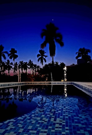 A swimming pool with a tiled floor and palm trees in the background. - BEAUTIFUL PLAYA BLANCA/BARRA DE POTOSI ESCAPE, 2 BEDROOM APT, POOL, SLEEPS 6 (Barra De Potosi)