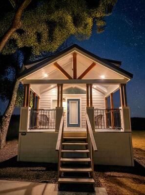 A two-story house with a balcony and a staircase leading to the entrance. - Tiny Home overlooking 1,800 Acres! Waxahachie Tx 30 to Dallas (Waxahachie)