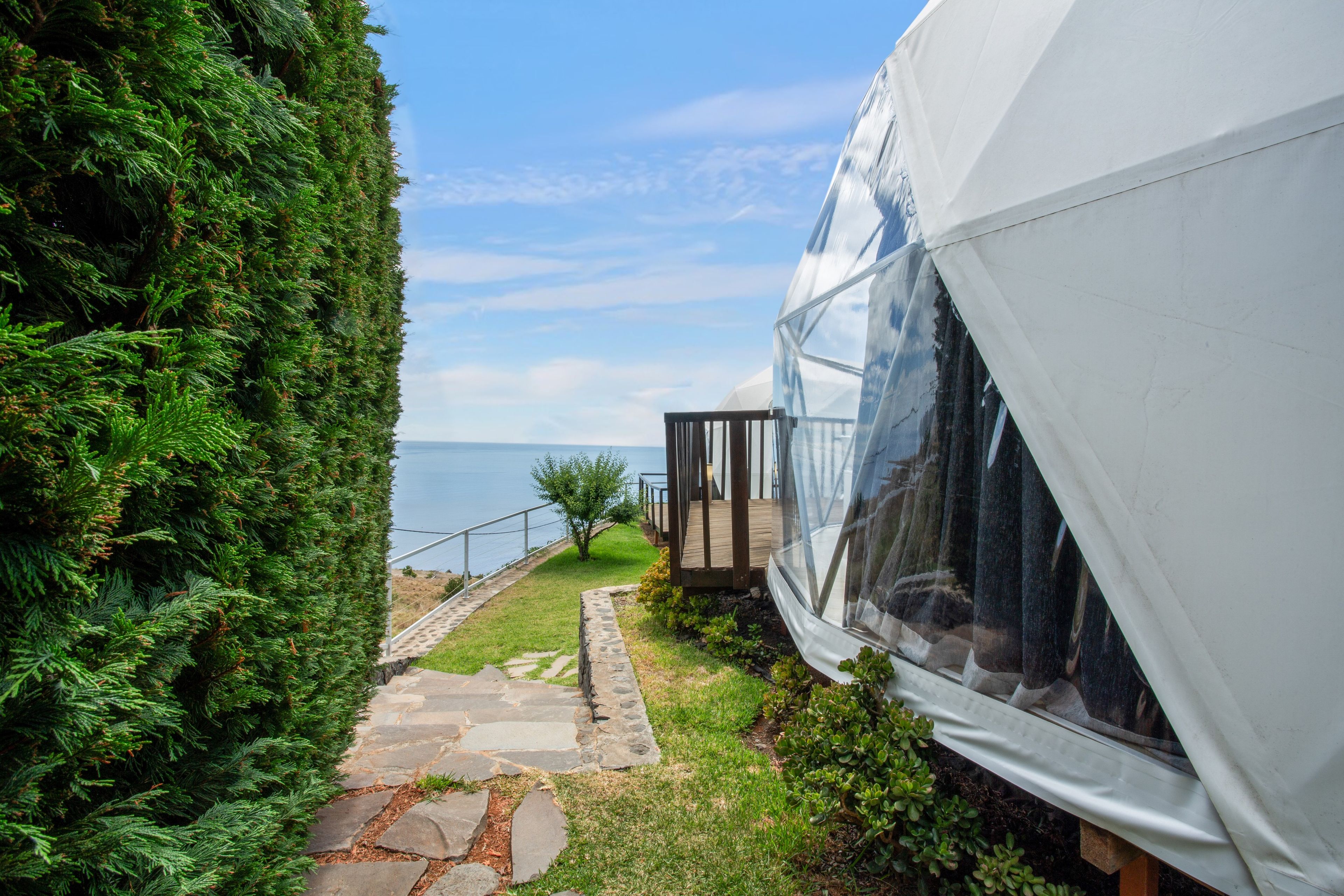 A white tent-like structure with a clear view of the sea.
