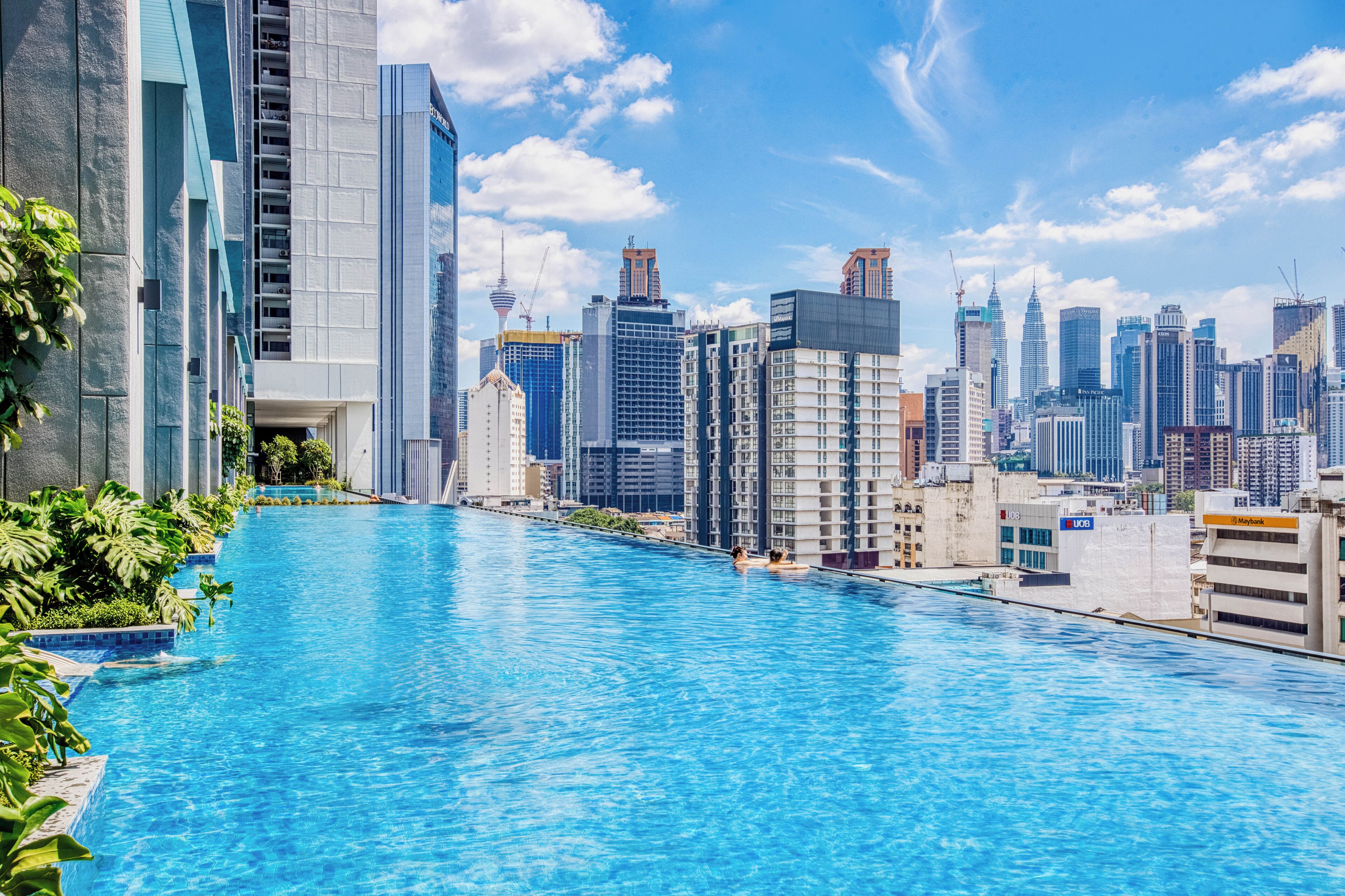 A swimming pool with a city skyline in the background.
