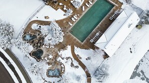 An aerial view of a resort with a swimming pool, hot tubs, and a covered area. - Yampa Valley Views, Hot Tub + Wildhorse Gondola Access | Konik Chalet (Steamboat Springs)