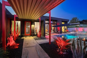 A modern house with a pool, red lighting, and a covered patio area. - Welcome to Casa Black - 3 Bedroom 3 Bathroom in the Palm Springs Area (Palm Springs)