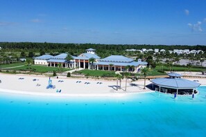 A resort with a beachfront, a pool area, and a building with a blue roof. - Plush 2BR Apt/Pool/Gym/King Bed/Beachwalk access (St. Johns County)