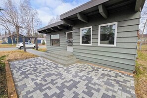 A residential building with a paved walkway leading to the entrance. - Easy Single-level Anchorage Home Near Parks and Trails (Anchorage)
