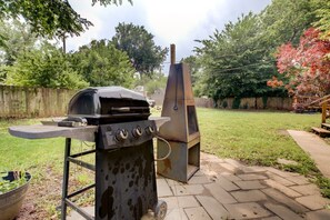 An outdoor grill setup with a chimney, a flat grill surface, and a side table. - Spacious Home, Dual King Suites, Central Manhattan (Manhattan)
