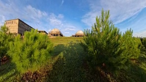 A landscape with two dome-shaped buildings and a pathway leading to them. - Eramon Paradise 360 (San Antonio de la Cruz)
