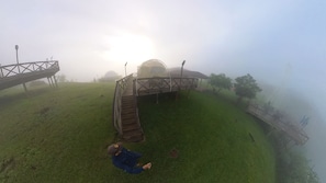 A grassy area with a wooden structure, possibly a gazebo, and a bridge. - Eramon Paradise 360 (San Antonio de la Cruz)