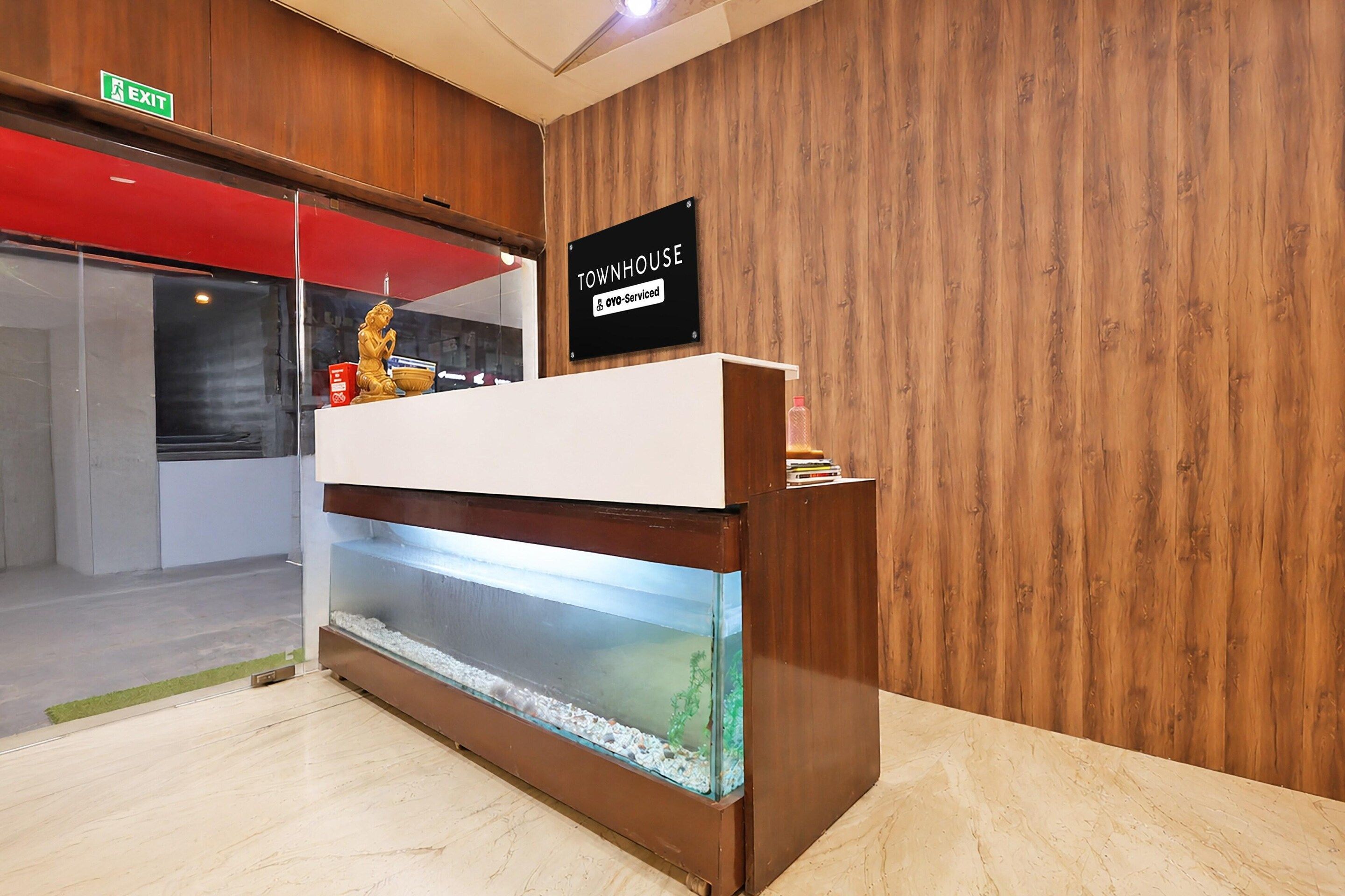 A reception desk with a sign indicating it's serviced by OYO.