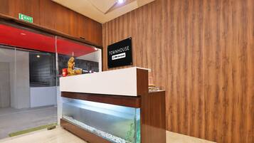 A reception desk with a sign indicating it's serviced by OYO.