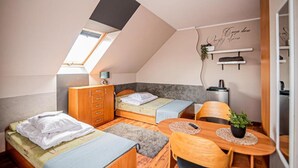 A compact room with a loft bed, a desk, and a small seating area. - Studio for 2 People, Close to the sea (Kamien Pomorski)