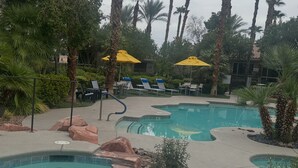 A pool area with multiple pools, lounge chairs, and umbrellas. - 3/2bth Supercondo in delightful Las Vegas with full gym, jacuzzi n pool for you! (Las Vegas)