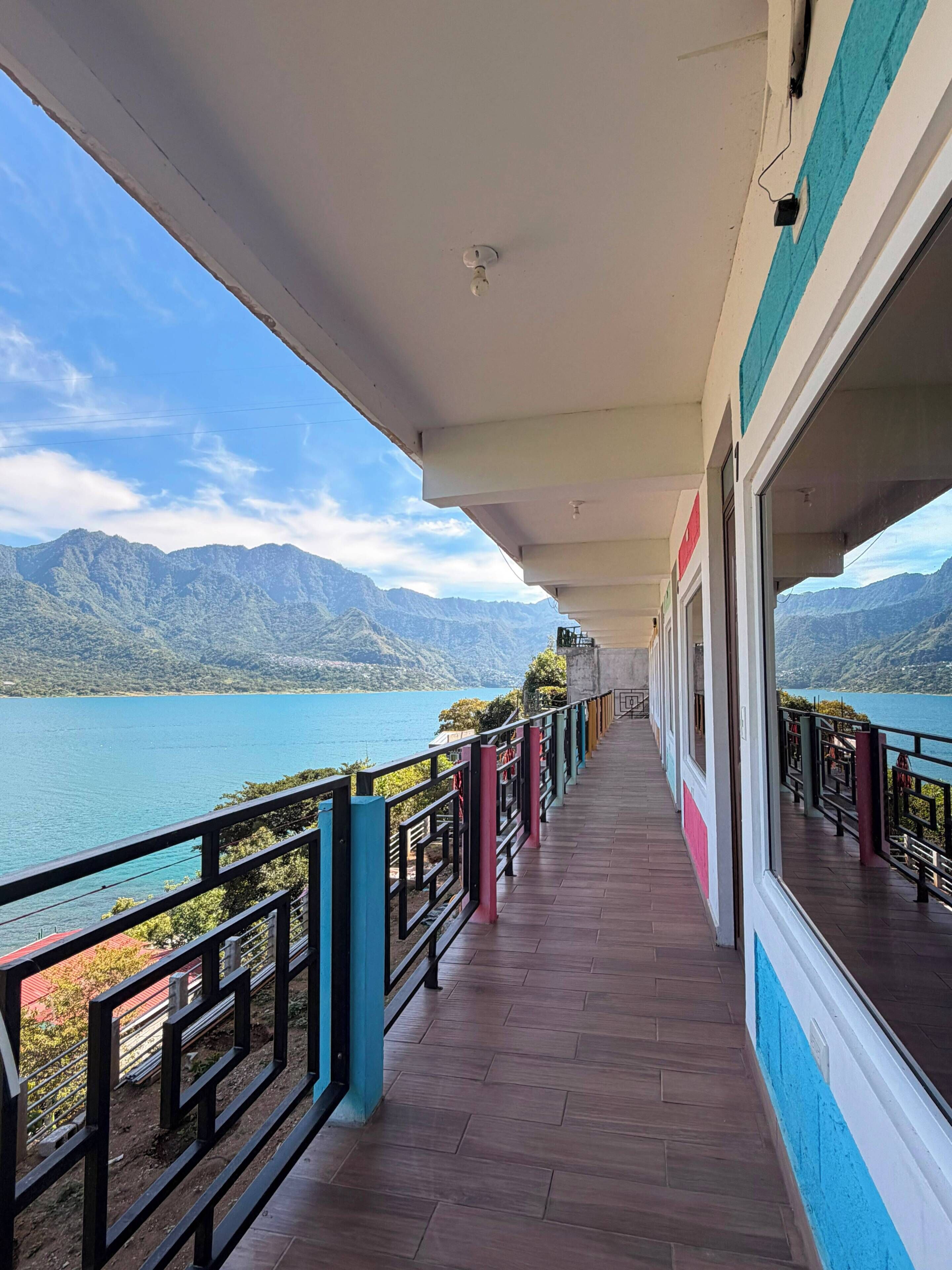 A corridor with a view of a lake and mountains.
