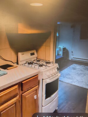 A kitchen with a stove, cabinets, and a microwave. - Cozy 1-bedroom apartment in fantastic Columbus with AC (Columbus)