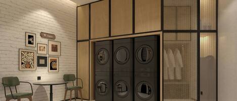 A modern interior with a white brick wall, framed artwork, a wooden cabinet, and a laundry area with circular windows.