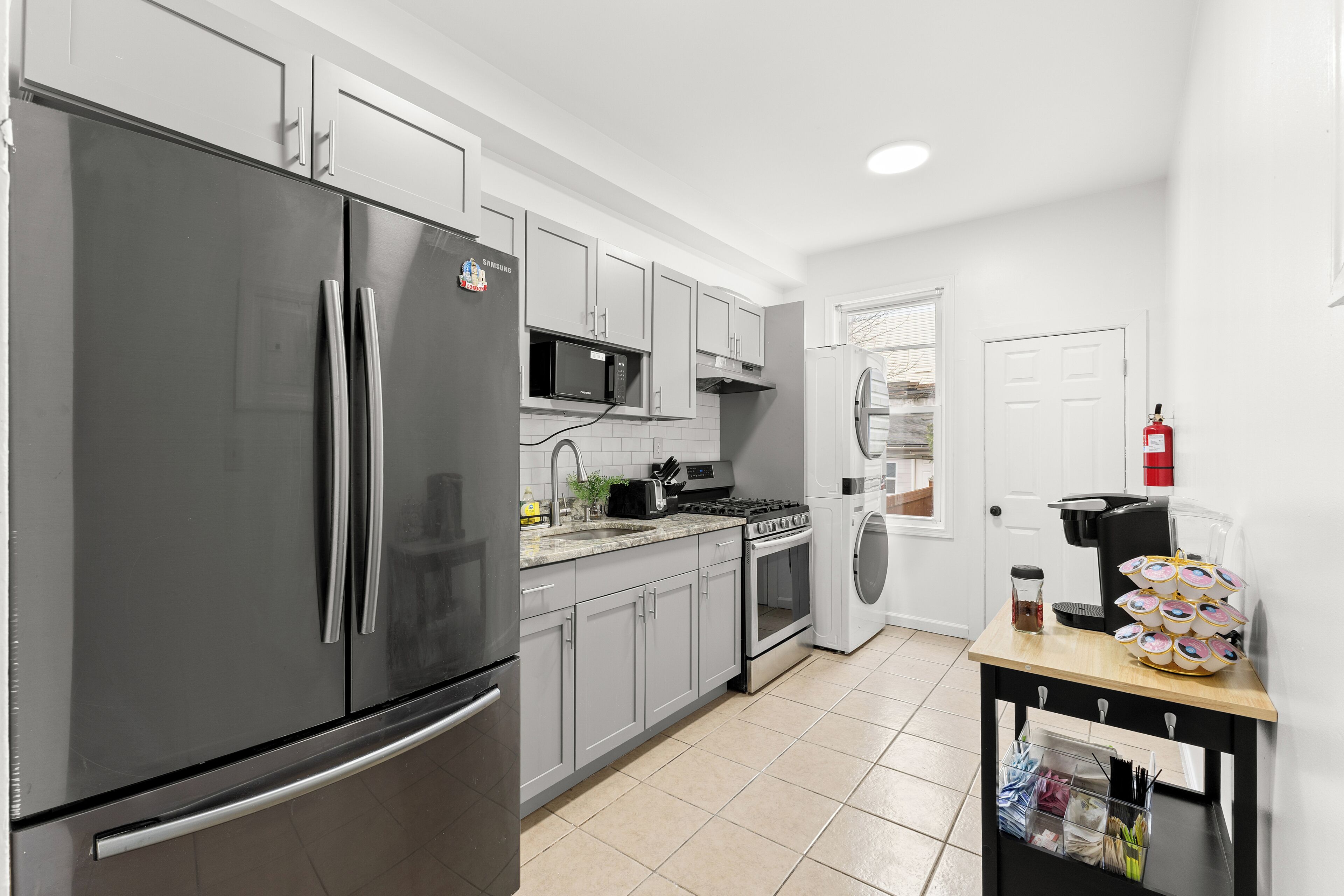 A modern kitchen with stainless steel appliances, a microwave, oven, and a coffee maker.
