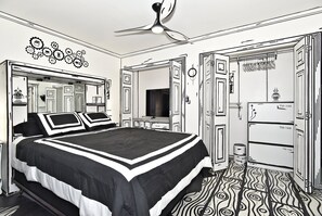 A bedroom with a bed, a ceiling fan, a wardrobe, and a mirror.