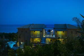 A two-story building with a balcony, a pool, and a view of the sea. - F Zeen (Kefalonia)
