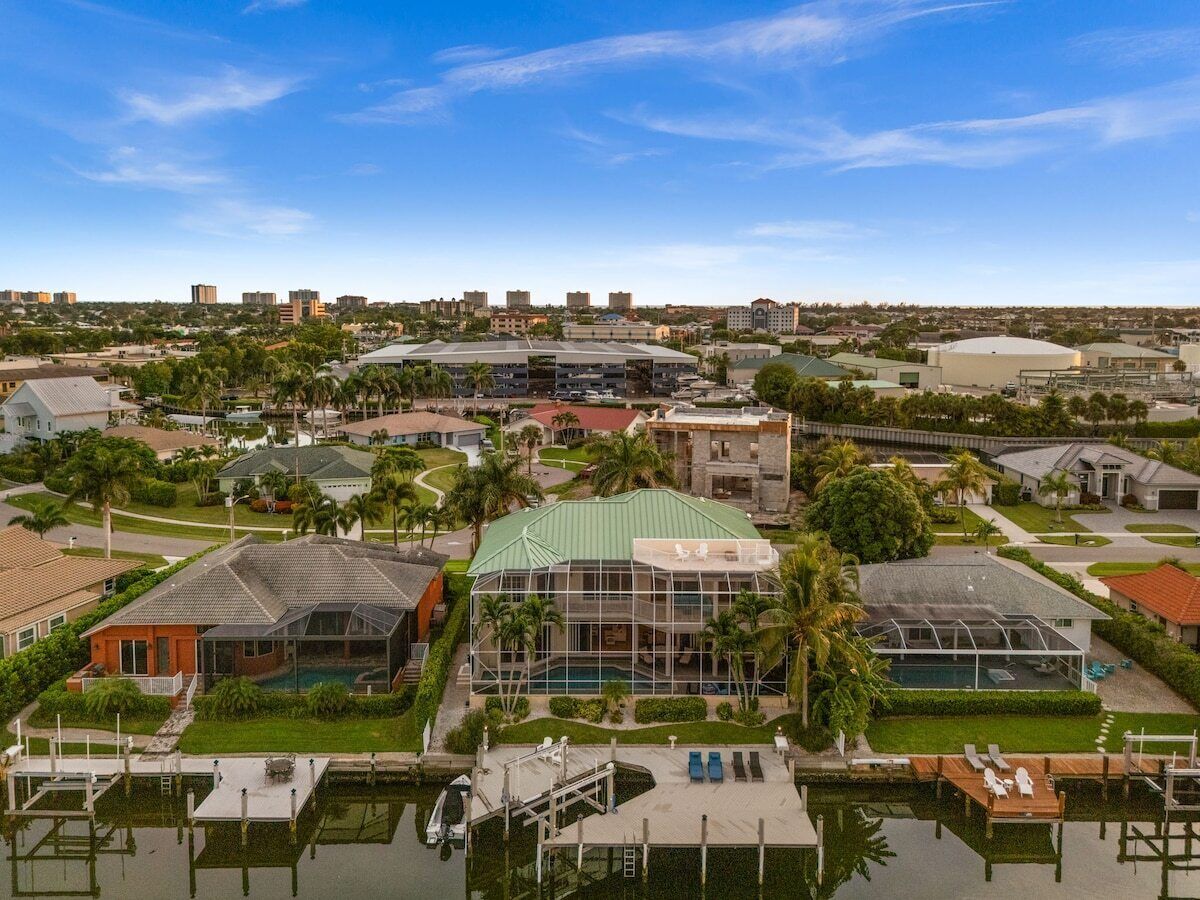 A residential area with a large building featuring a swimming pool and a covered outdoor area.