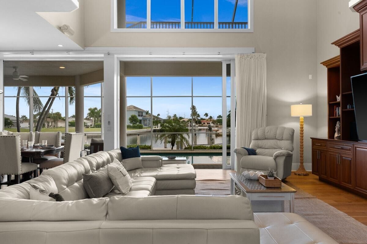 A spacious living room with a large sectional sofa, a recliner, and a television.