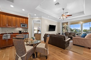 A modern living space with a kitchen, dining area, and seating area. - Waterfront Estate • Rooftop • Heated Pool/Spa (Marco Island)