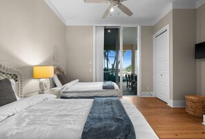 Bright double bedroom with patio access and tropical water views