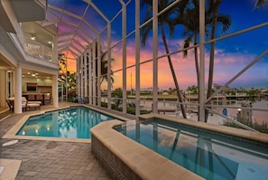 Screened waterfront pool & spa with stunning sunset views