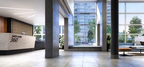 A modern lobby with a reception desk, large windows, and a view of a building outside. - Santa Isabel Santiago by Domus Travels (Santiago)