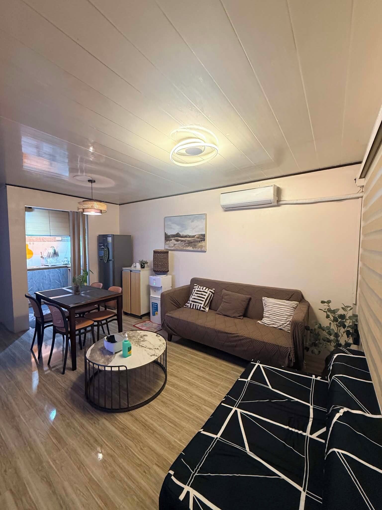 A compact living space with a dining area, a sofa, and a coffee table.
