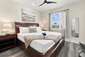 Spacious private king bedroom located on the third floor features a comfortable king-size bed, 40" Smart TV, and attached ensuite bathroom - River District Residence | Walk to Armature Works | 3BR Townhome with Garage & Private Yard (Tampa)
