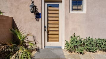 A building with a wooden door, a sign reading 'Courtyard Casita,' and a small window above the door.