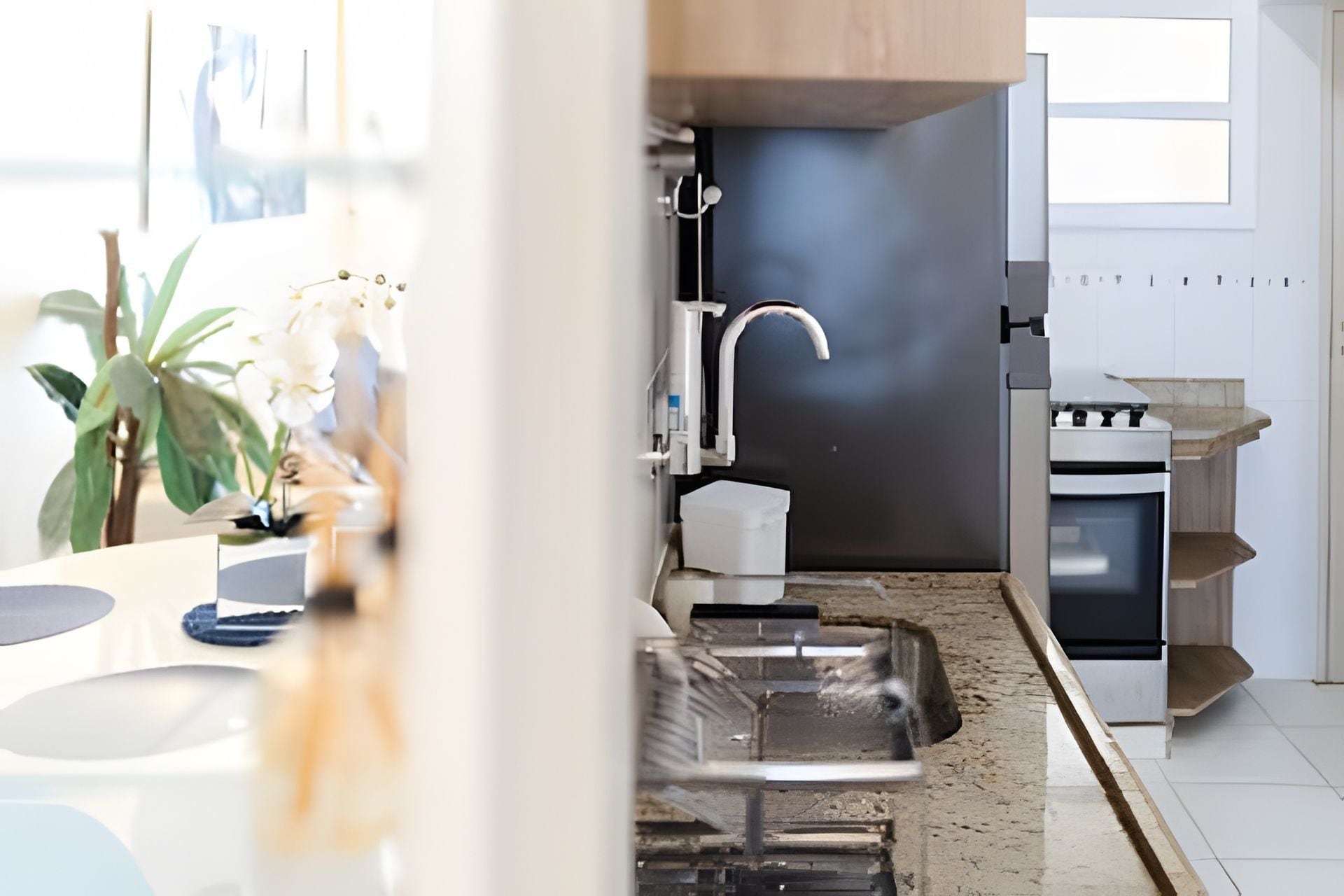 A modern kitchen with a built-in oven, a sink, and a countertop.