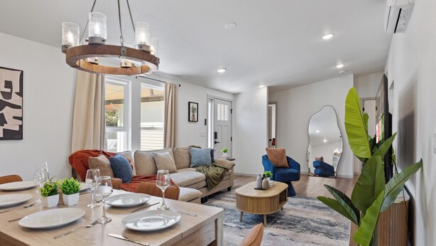 A modern living room with a dining area, a sofa set, and a coffee table.