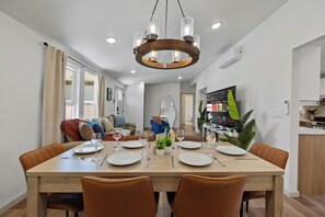 A dining area with a wooden table set for four, surrounded by brown chairs. - 4BD 3BA Modern Home with Backyard. Near SF, Concord, Oakland & Napa Winery (Concord)