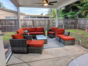 A covered patio area with outdoor furniture, a ceiling fan, and a view of the backyard. - A Haven of Sun and Fun in Largo; A Private Oasis in the heart of everything (Largo)