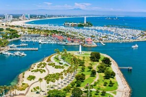 A marina with boats, a lighthouse, and a park area with pathways and trees. - 2BDR Belmont Shore Retreat <> Steps from the Beach (Long Beach)