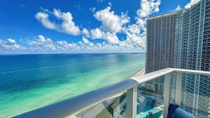 A high-rise building with a clear view of the ocean and a beach.