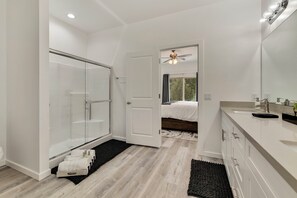 A modern bathroom with a glass shower, a vanity with a mirror, and a ceiling fan. - NEW LISTING SALE: Peaceful 2BD/2.5BA Townhome w/ Forest Setting, Patio, & Garage (Payson)