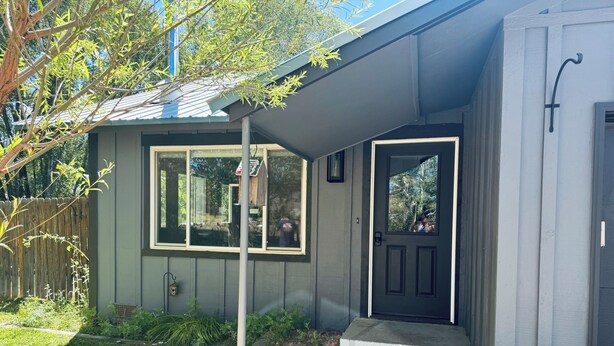 A residential house with a front door, a mailbox, and a small porch area. - Large Backyard, River Views & Mountain Adventures (Gunnison)