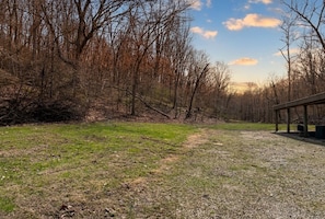 A park with a gravel path, grassy areas, and leafless trees.