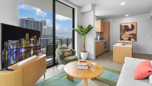 A modern apartment with a city view, a flat-screen TV, a dining area, and a kitchen. - The Crosby Miami Worldcenter (Miami)