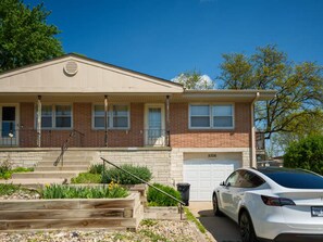 A two-story house with a garage, a front porch, and a driveway.